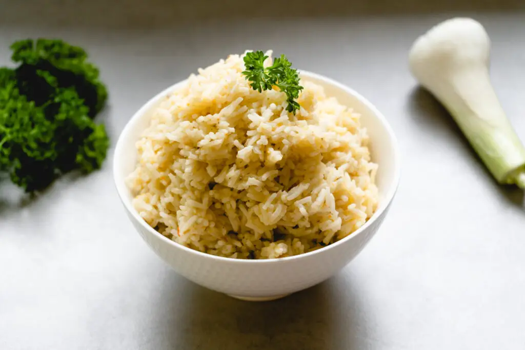 a bowl of rice with parsley on top