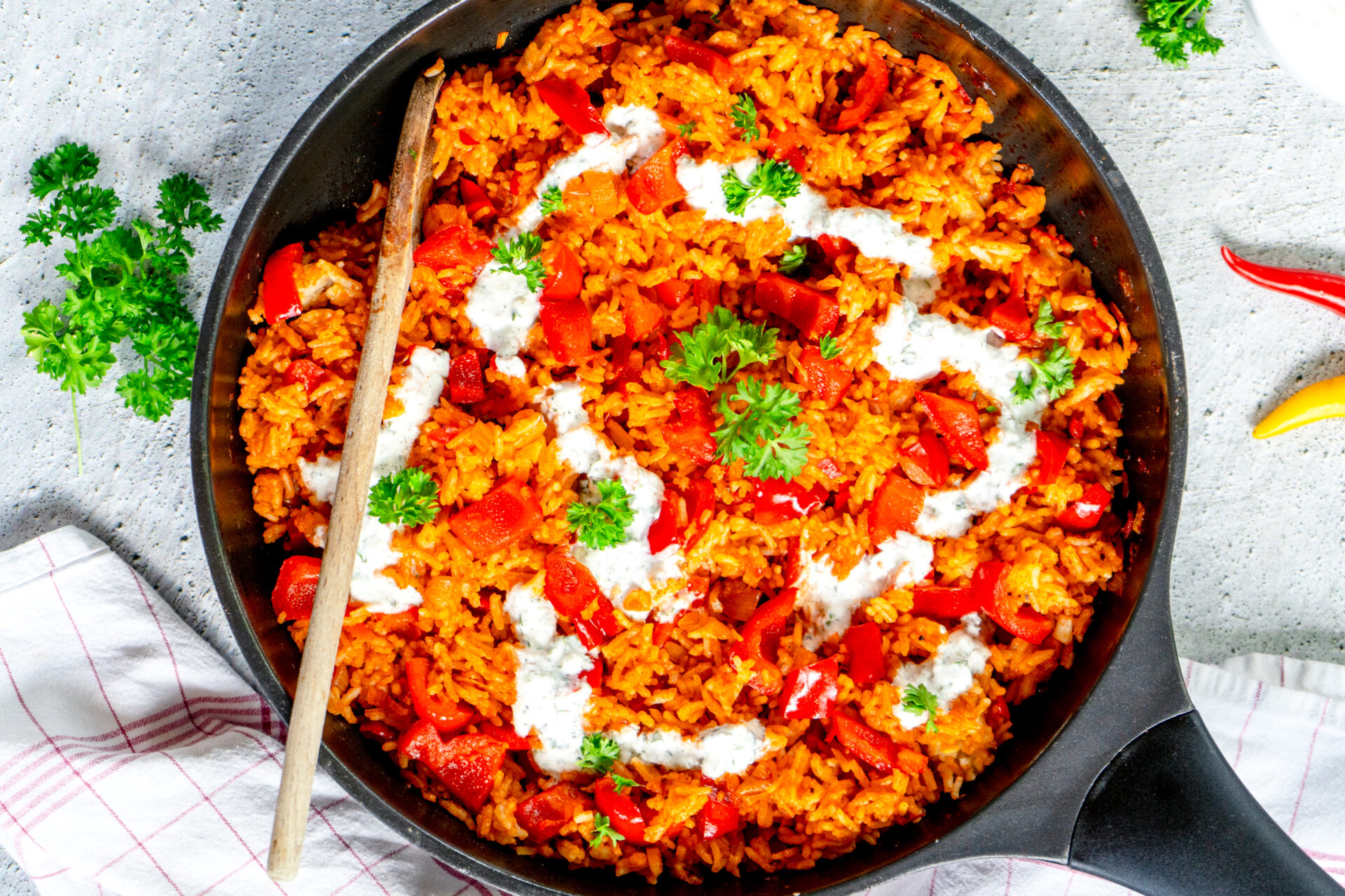 a pan of rice with vegetables and sauce